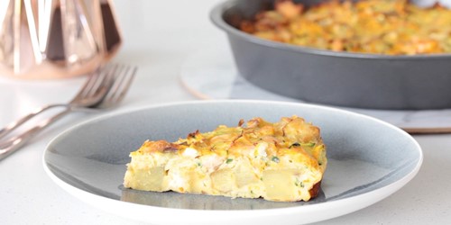Slice of homemade salmon frittata with potatoes, made using Sealord canned salmon, served on a plate.