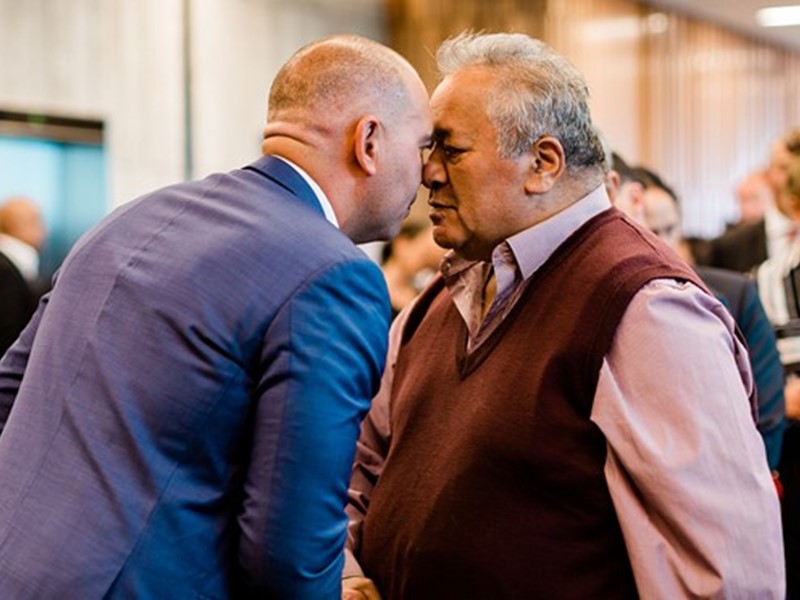 ChatGPT said: Sealord representative and iwi member greeting each other with a traditional Māori hongi, celebrating their partnership agreement with cultural respect and unity.