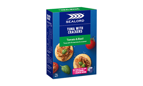 Sealord Tuna with Crackers – Tomato & Basil flavour in boxed packaging, featuring tuna spread on round crackers with basil leaves and tomatoes.