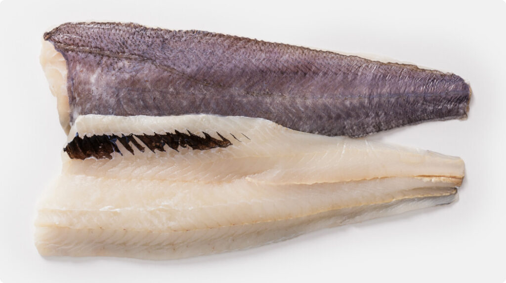 Two Hoki untrimmed fillets (UTF), one skin-on and one skinless, with visible pin bones and natural texture.
