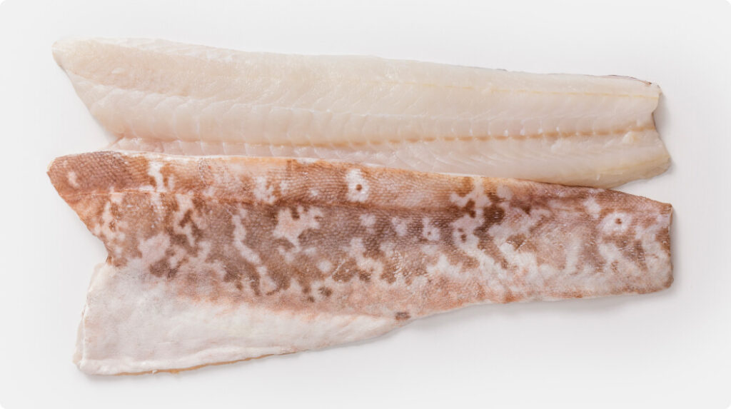 Two raw Ling fillets, one skin-on and one skinless, showcasing firm white flesh and mild marbling.